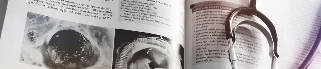 Ein medizinisches Lehrbuch mit einem aufliegenden Stethoskop.